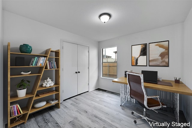 office area with light hardwood / wood-style floors