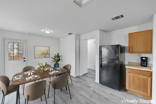 dining area with light hardwood / wood-style flooring