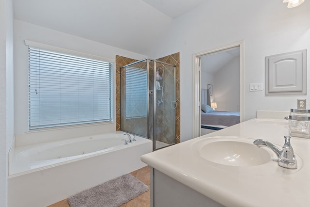 bathroom with lofted ceiling, vanity, tile patterned flooring, and independent shower and bath