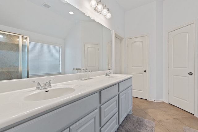 bathroom with tile patterned flooring, walk in shower, vanity, and vaulted ceiling