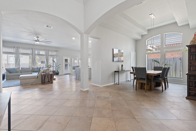 dining area featuring light tile patterned flooring and ceiling fan with notable chandelier