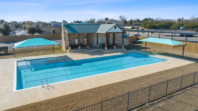 view of swimming pool with a patio area and an outbuilding