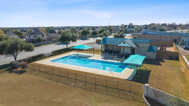 view of pool with a lawn and a patio