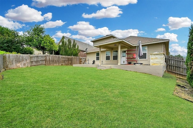 rear view of house featuring a patio area and a lawn