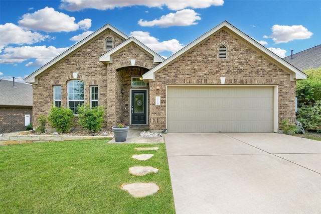 view of front of property with a front yard and a garage