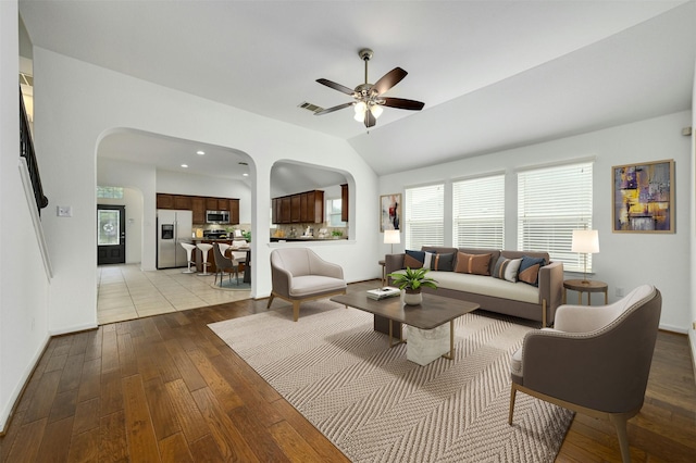 living room with ceiling fan, lofted ceiling, and light hardwood / wood-style flooring