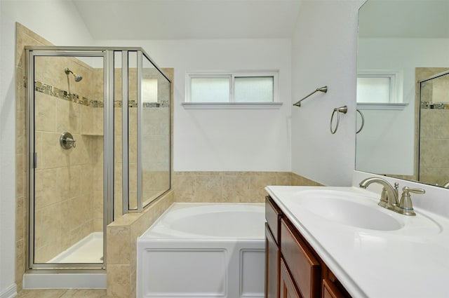 bathroom featuring plenty of natural light, shower with separate bathtub, and vanity