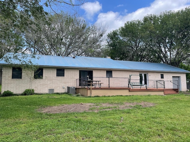 back of property featuring a deck, central AC unit, and a lawn