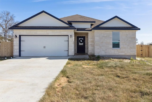 111 Lavender Cv, Dale, TX 78616 - view of front of property with stone siding, an attached garage, driveway, and a shingled roof