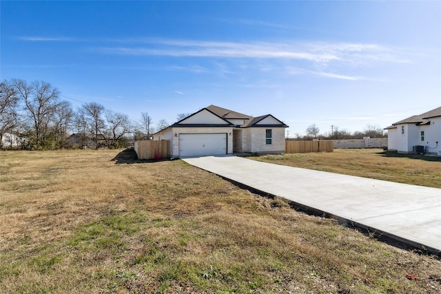 ranch-style home featuring a garage and a front lawn