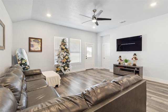 living room with ceiling fan, hardwood / wood-style floors, and lofted ceiling