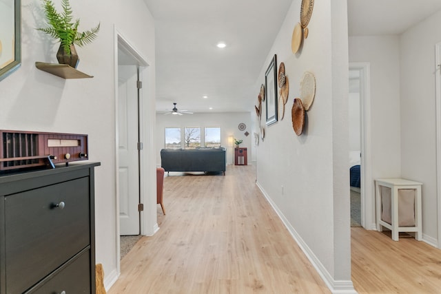 corridor with light hardwood / wood-style flooring