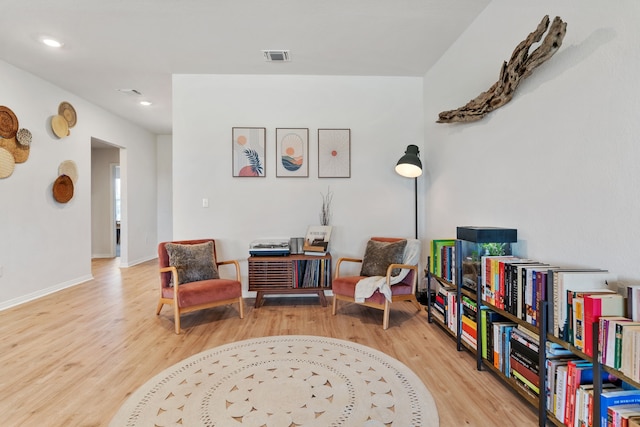 sitting room featuring light hardwood / wood-style flooring