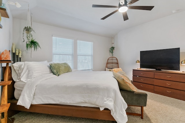 carpeted bedroom with ceiling fan and lofted ceiling