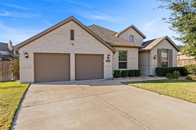 view of front of house with a front yard and a garage