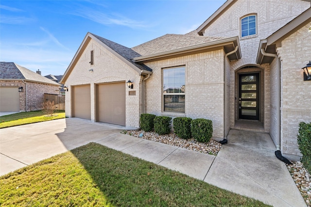 french country inspired facade with a front yard and a garage