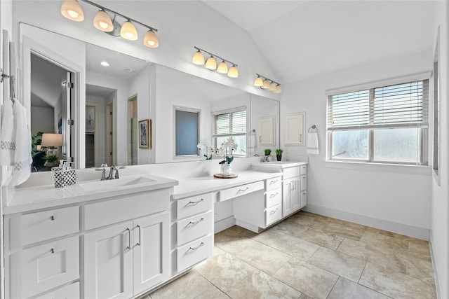 bathroom featuring vanity and vaulted ceiling