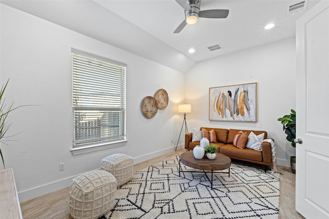 living room featuring ceiling fan and lofted ceiling