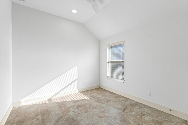 spare room featuring lofted ceiling