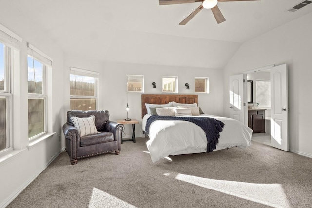 bedroom featuring carpet floors, lofted ceiling, baseboards, ceiling fan, and ensuite bathroom