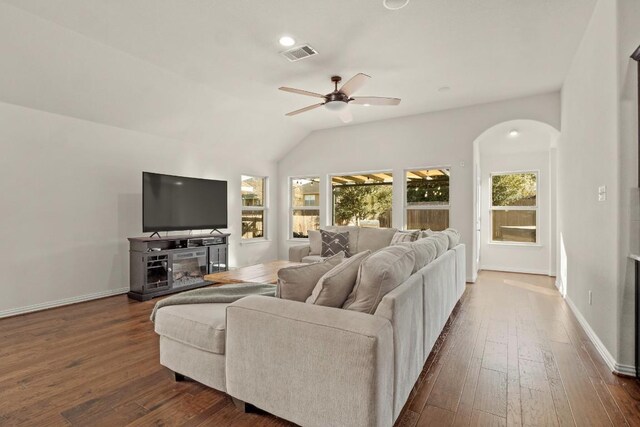 living room featuring dark wood-type flooring, ceiling fan, and lofted ceiling