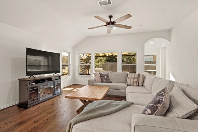 living room featuring lofted ceiling, a wealth of natural light, dark hardwood / wood-style floors, and ceiling fan