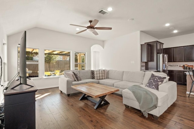 living room featuring arched walkways, a ceiling fan, dark wood finished floors, recessed lighting, and vaulted ceiling