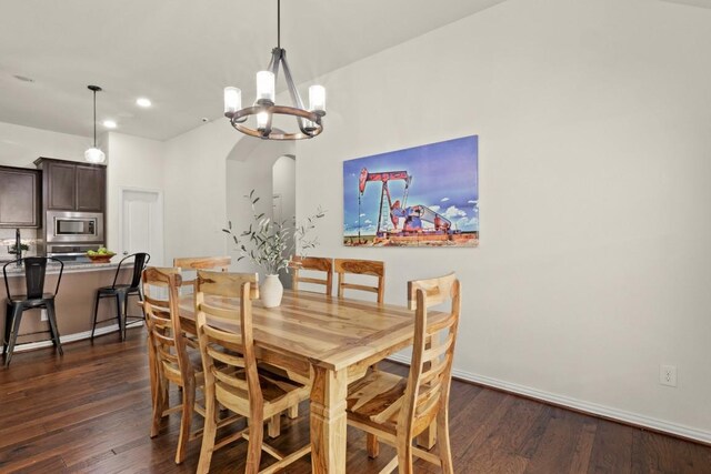 dining room featuring dark hardwood / wood-style flooring and a notable chandelier