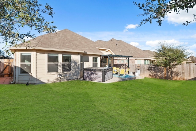 rear view of house with a yard, a pergola, a patio area, and a hot tub