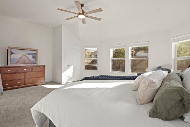 bedroom featuring vaulted ceiling, light carpet, and ceiling fan