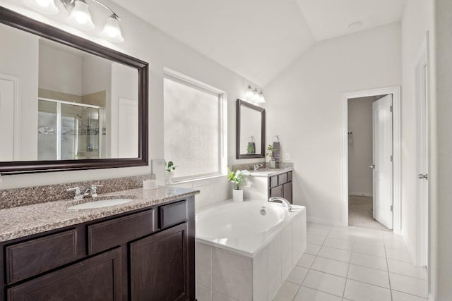 full bathroom featuring a shower stall, lofted ceiling, tile patterned floors, a bath, and two vanities