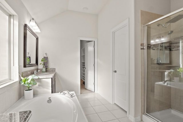 full bathroom with a shower stall, tile patterned flooring, a bath, vaulted ceiling, and vanity