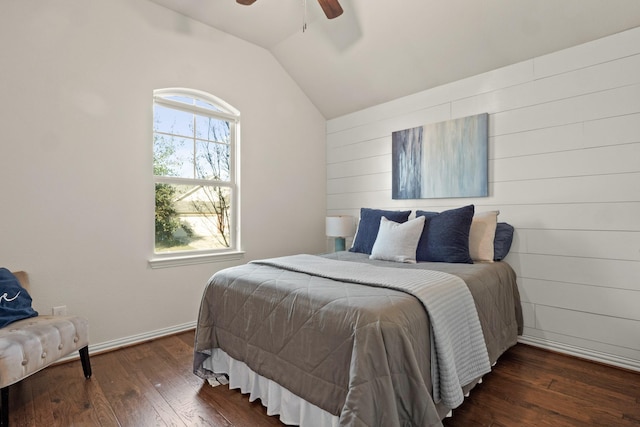 bedroom featuring dark hardwood / wood-style flooring, vaulted ceiling, and ceiling fan