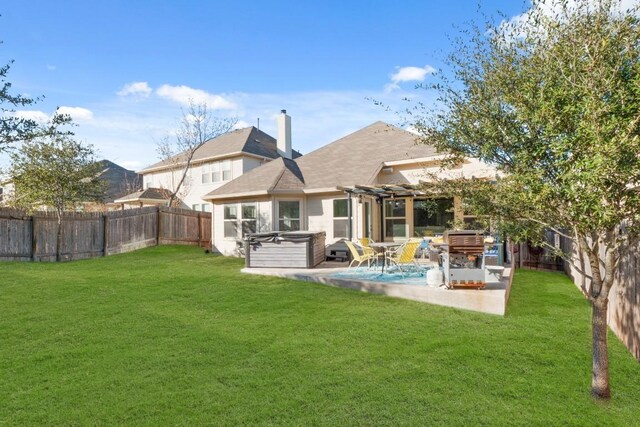 back of property featuring a hot tub, a pergola, a patio, and a lawn