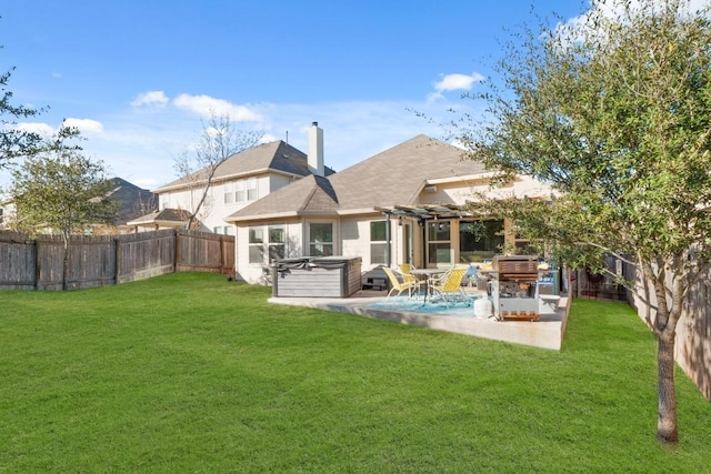 back of house with a hot tub, a pergola, a chimney, and a patio area