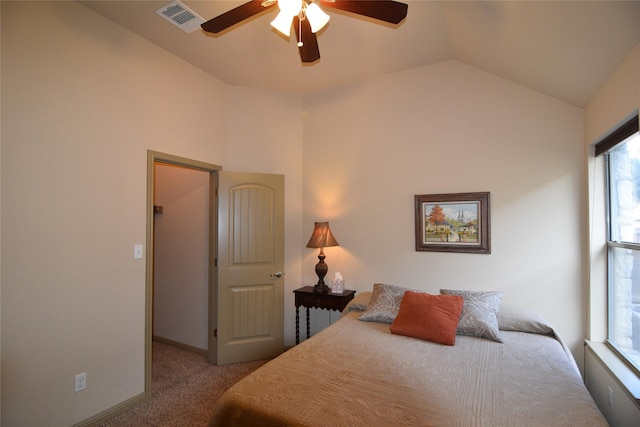 bedroom with ceiling fan, light carpet, and vaulted ceiling