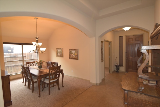 tiled dining space with a chandelier