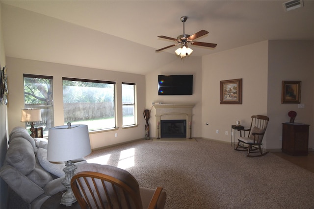 carpeted living room featuring ceiling fan and vaulted ceiling