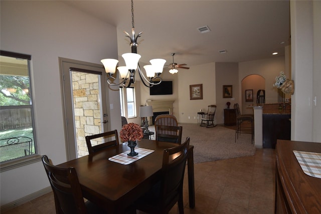 dining room featuring ceiling fan with notable chandelier