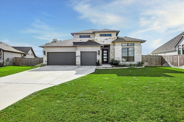 prairie-style house featuring a front yard and a garage