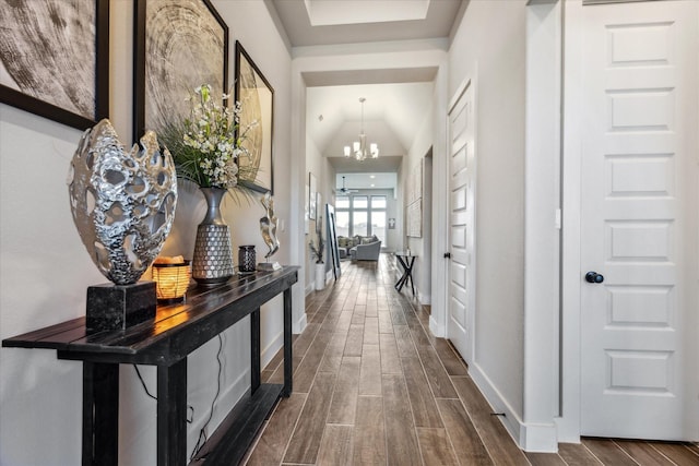 corridor with an inviting chandelier