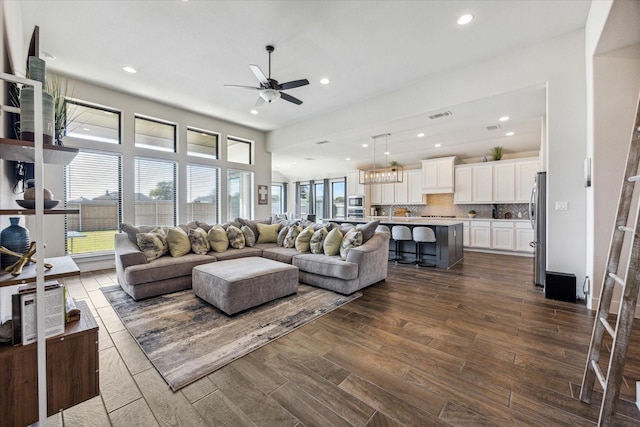 living room with ceiling fan and dark wood-type flooring