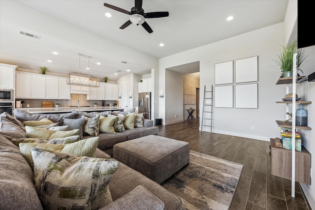 living room with ceiling fan, dark wood-type flooring, and sink