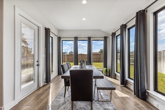 sunroom featuring vaulted ceiling