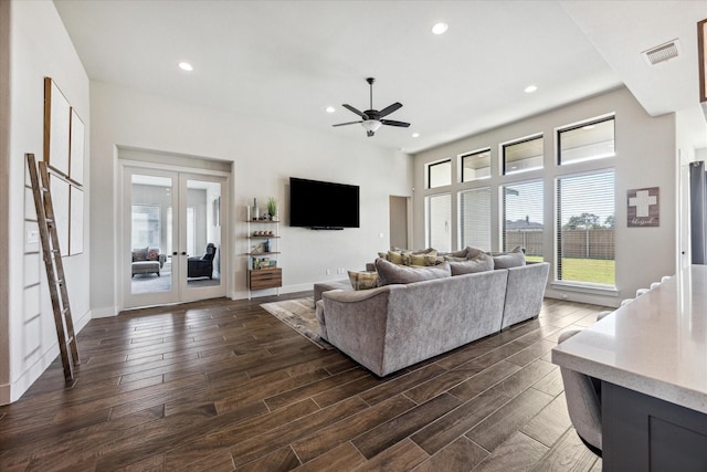 living room featuring ceiling fan and french doors