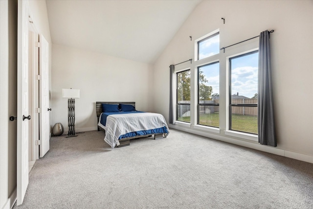 carpeted bedroom with lofted ceiling