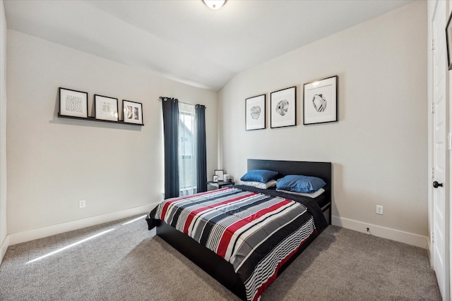 bedroom featuring light colored carpet and lofted ceiling