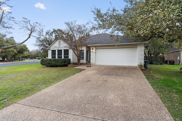 view of front of property featuring a garage and a front lawn