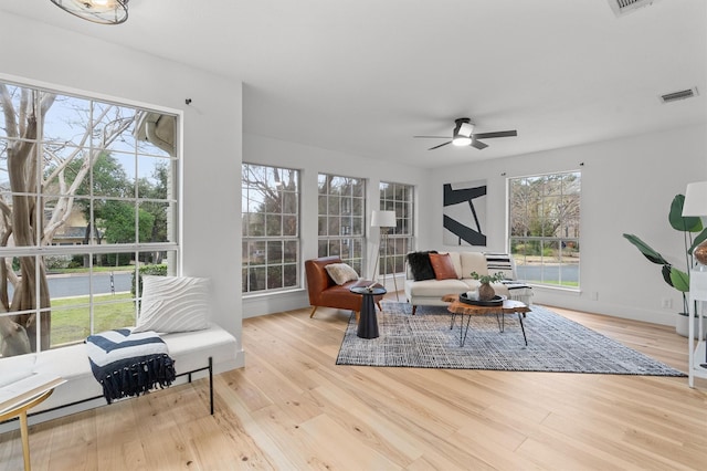 living room featuring light wood-type flooring and ceiling fan