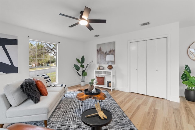 living room with ceiling fan and light hardwood / wood-style floors